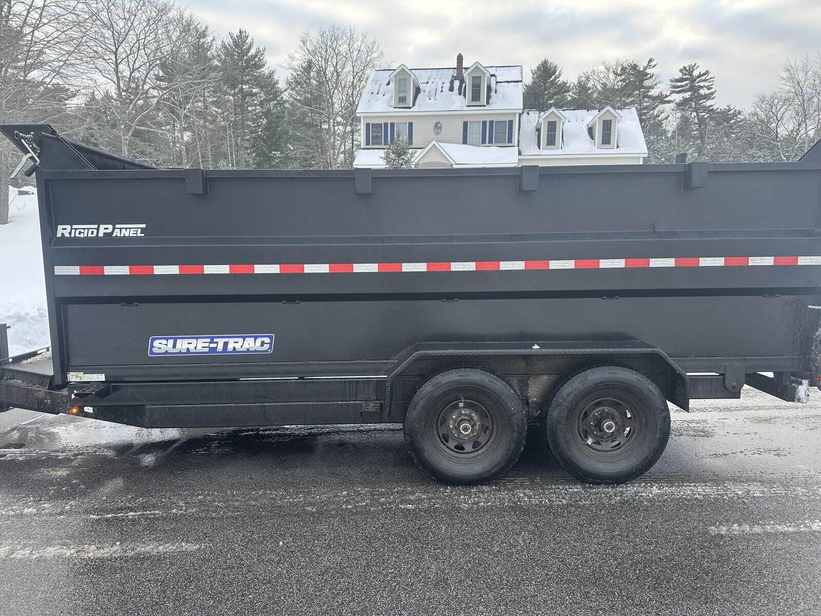 Loaded junk removal trailer at a residential job