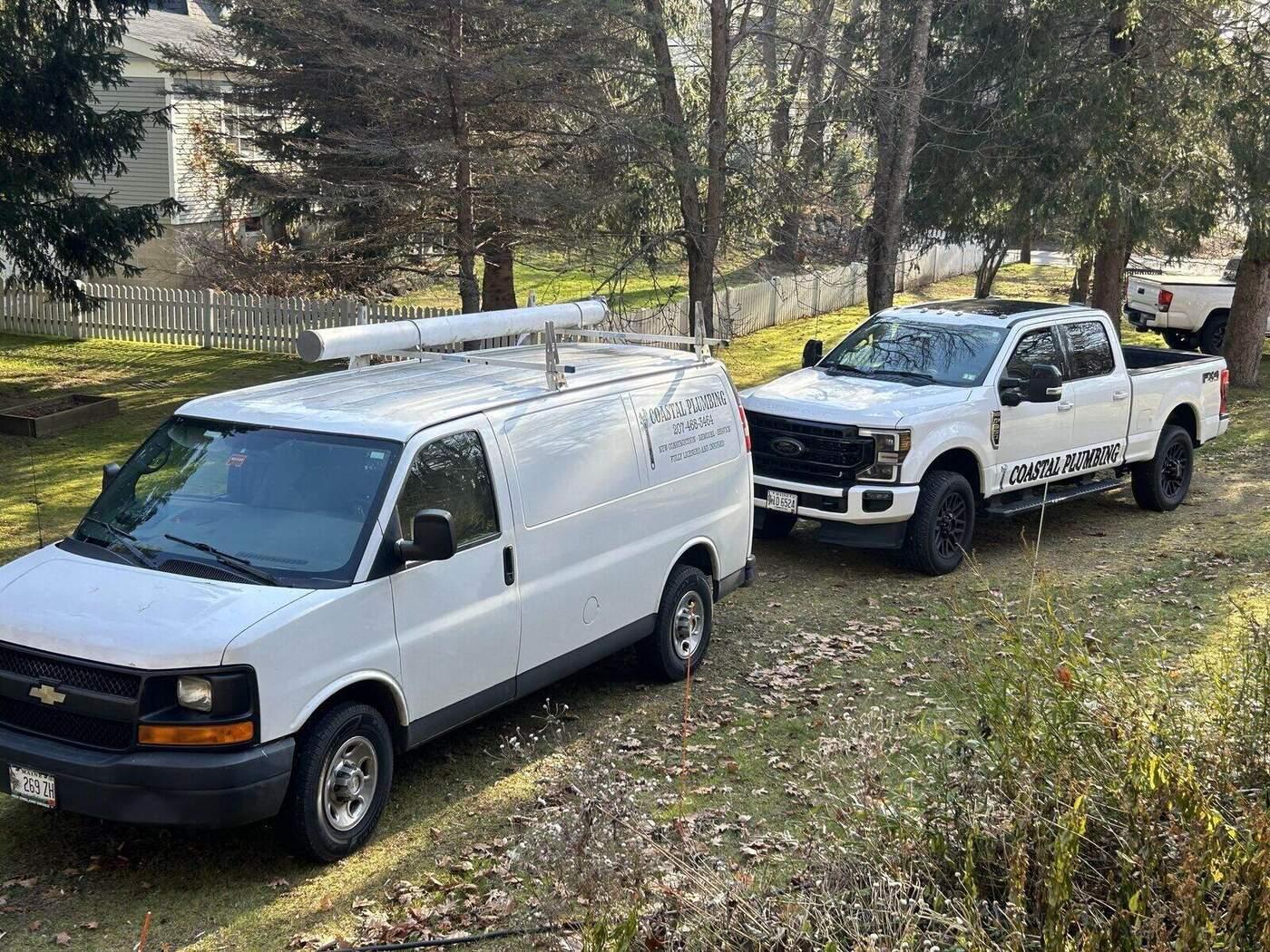 Work trucks and equipment staged for a tree service job